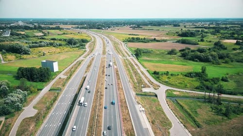 Urban veins: Drone footage over highway interlaced, reflecting non-stop flow of city traffic. Vehicu