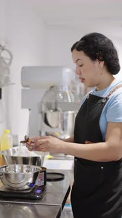 Pastry Chef Weighing Ingredients on Kitchen Scale