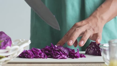 Man Chopping Purple Cabbage For Salad