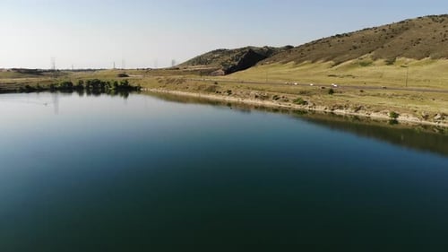 A duck swims on a calm lake.