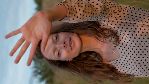 Young Woman Smiling and Covering Face in Field