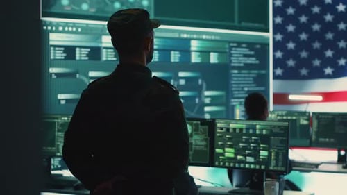 US Military Man Supervising Threat Detection Activity in High Tech Office