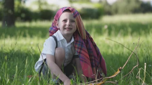 Funny Portrait of a Little Boy in the Park in Summer