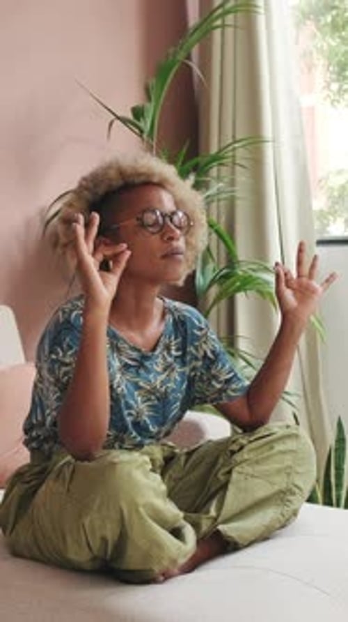 Young Woman Meditating Indoors