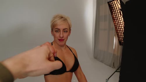 Production Crew Filming Fitness Bikini Commercial with Female Model in Studio