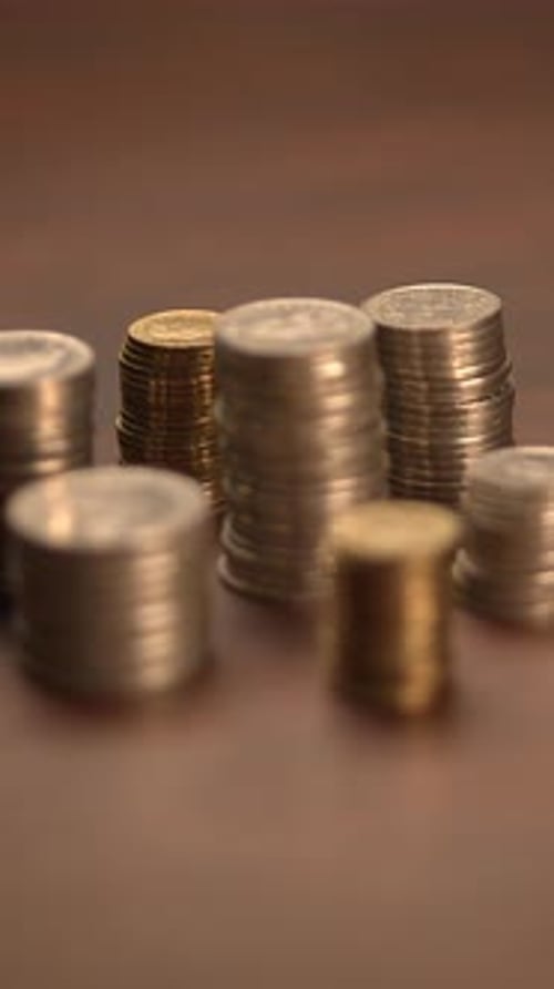 Stacks of Golden and Silver Coins on Surface