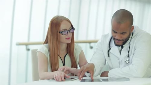 Doctor and Patient Discussing X-Ray in Office