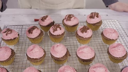 Drizzling Chocolate Ganache on Top of Bake Chocolate Raspberry Cupcakes