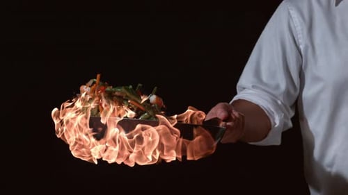 Chef Tossing Vegetables in Flaming Frying Pan