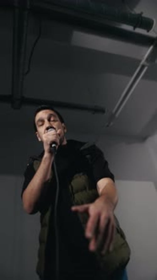 Expressive Young Adult Singing Into Microphone