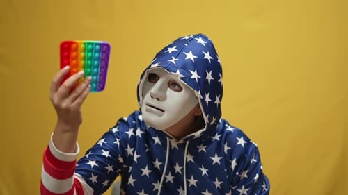 Masked Person Holding Colorful Pop-It Toy