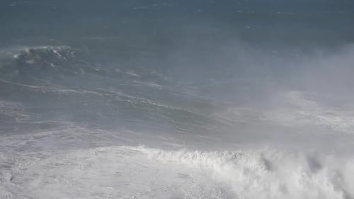 Massive crashing wave in Nazare, Portugal showcasing extreme ocean force and power