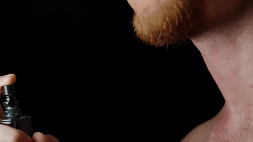 Man Sprays Cologne on Neck Close-up