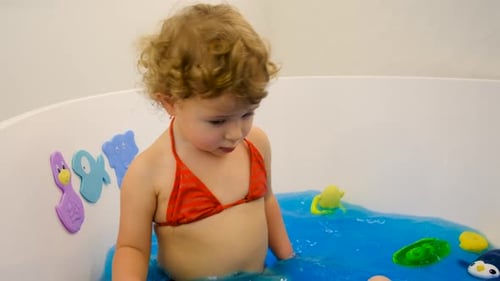 The Child Bathes in the Bath Paint Blue Color