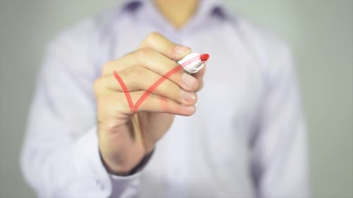 Person Draws Red Check Mark on Glass