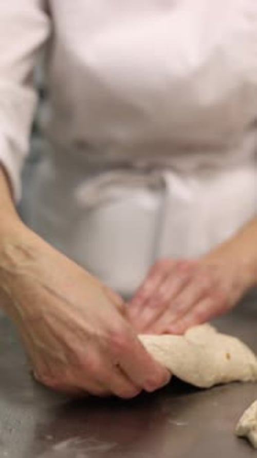 a chef makes bread in a bakery