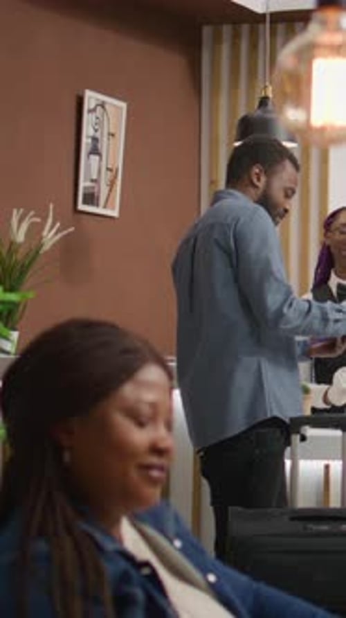 Hotel Guest Signing Documents at Reception Check-In