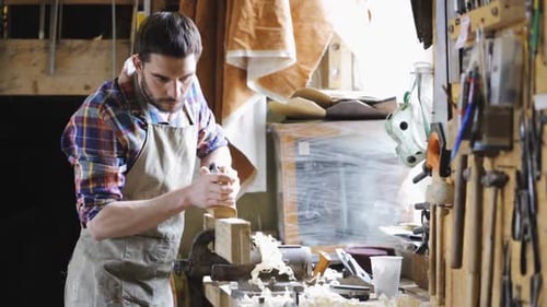 Man Crafting Woodworking Project at Workbench Inside