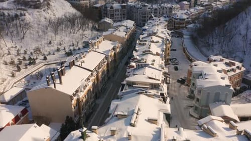 View From Drone Flying Over City Street Covered with Snow