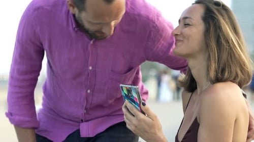 Happy Couple Meeting in City Near Beach and Using Smartphone Adult