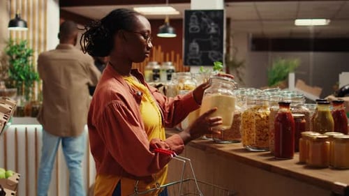 Woman Shopping For Dry Goods In Modern Grocery Store