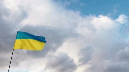 Ukrainian Flag Waving Peacefully Against Cloudy Sky