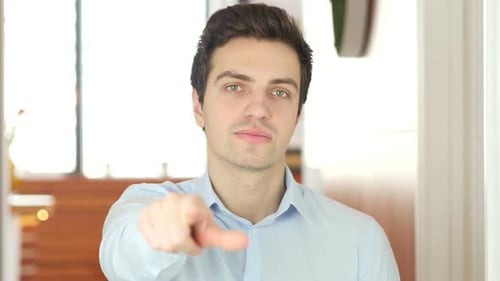 Young Adult Man Points at the Viewer