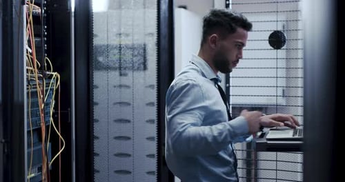 Technician Uses Laptop in Server Room