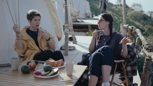 Friends Enjoying Breakfast Outdoors Near Tents