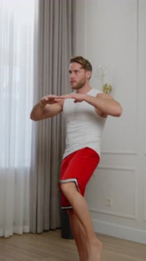 Young Adult Man Exercising in Living Room