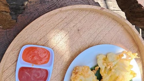 Beautiful fried tempe a traditional indonesian local food and sauce on a Round shape natural wooden