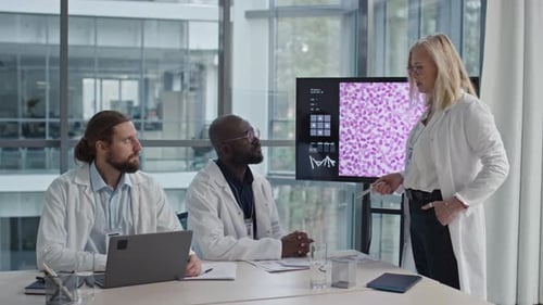 Medical Professionals Collaborate on Research in Modern Office