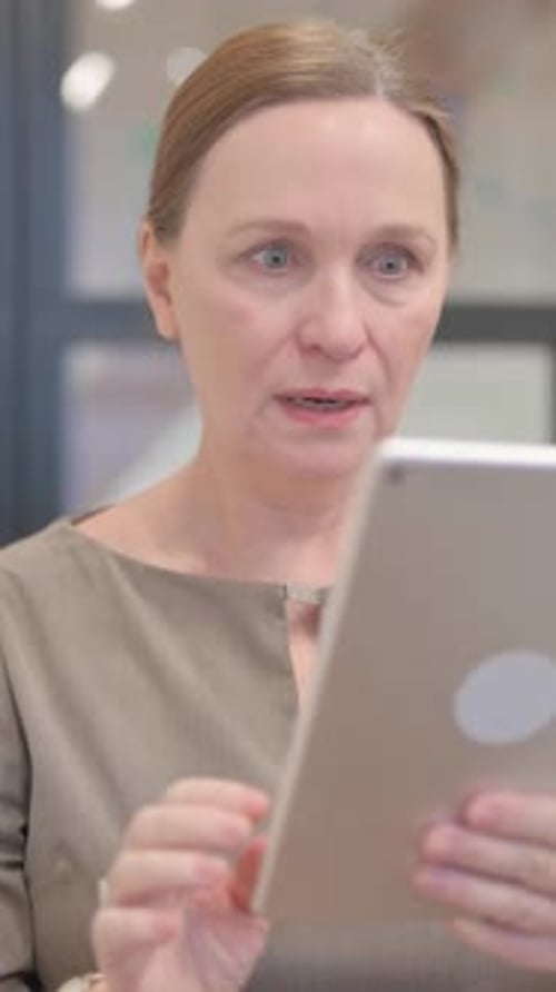 Woman Using Tablet Device Indoors, Close Up Portrait