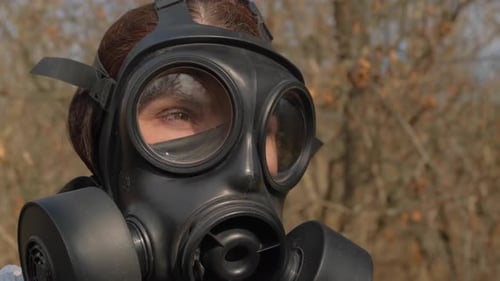 Person Wearing Black Gas Mask Outdoors
