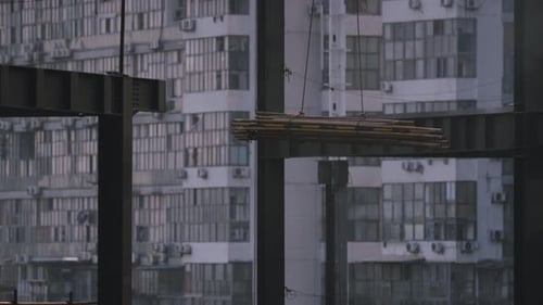 Crane lowers Equipment deep into site
