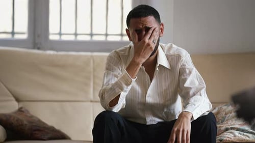 Dramatic young man feeling distraught and stressed from emotional pressure. Frustrated male person