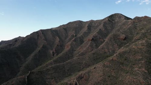 Backward Drone Dolly Revealing Giant Mountain Range, Rocky Formations