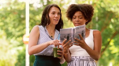 Tourism, Travel, Leisure, Holidays And Friendship Concept - Smiling Women With City Guide And Tak...