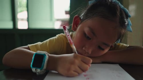 Girl Writing at Desk Inside Home Doing Homework