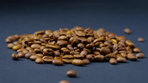 Closeup on Blackblue Background Lie Roasted Coffee Beans Laid Out in the Shape of a Heart