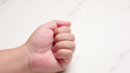 Hand Opens and Closes into Fist