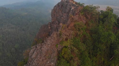 Aerial view of hut and mountains at sunrise, Laos.