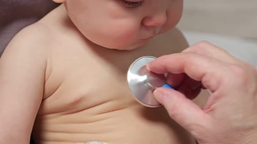 Infant Receives Medical Exam with Stethoscope