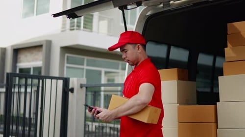 Delivery man, driver calling to customerr for sending parcel box package in the cargo truck at home