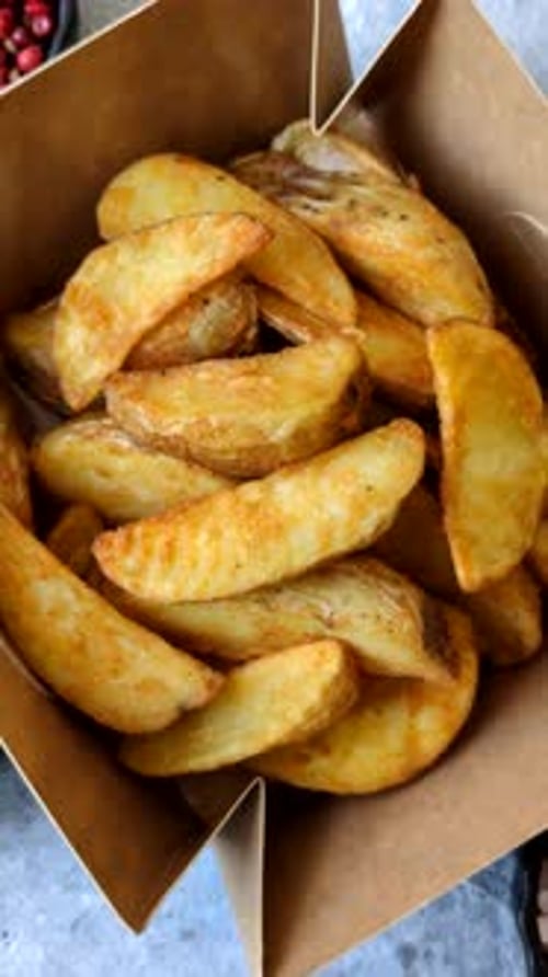 Potato wedges baked with garlic, herbs, and spices for lunch. Potato wedges