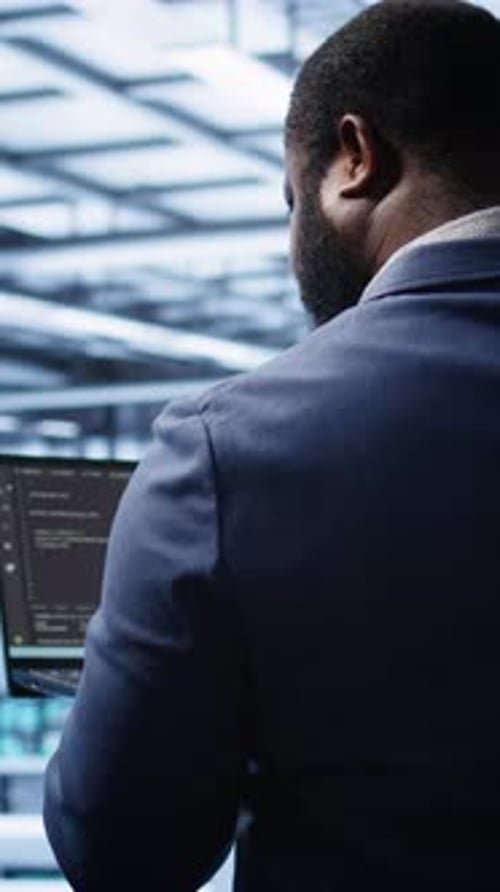 Vertical Video Programmer in Data Center Doing Yearly Maintenance Checkup Using Laptop