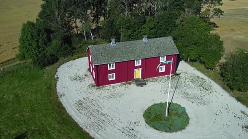 Picturesque Red House with Swedish Flag in Countryside