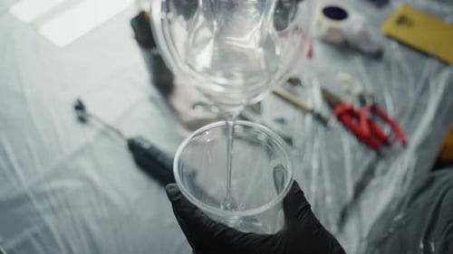 Pouring Resin Into A Cup In An Art Studio