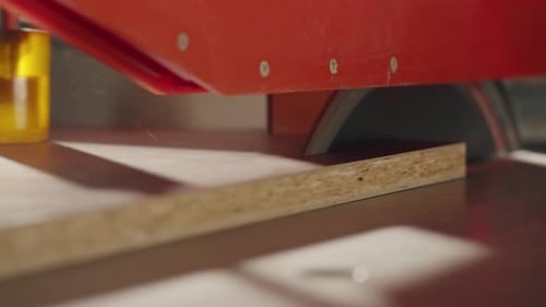Closeup of Carpenter Cutting a Wooden Plank Circular Saw on Wooden Factory Furniture Production