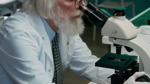 Scientist Using Microscope in Medical Laboratory
